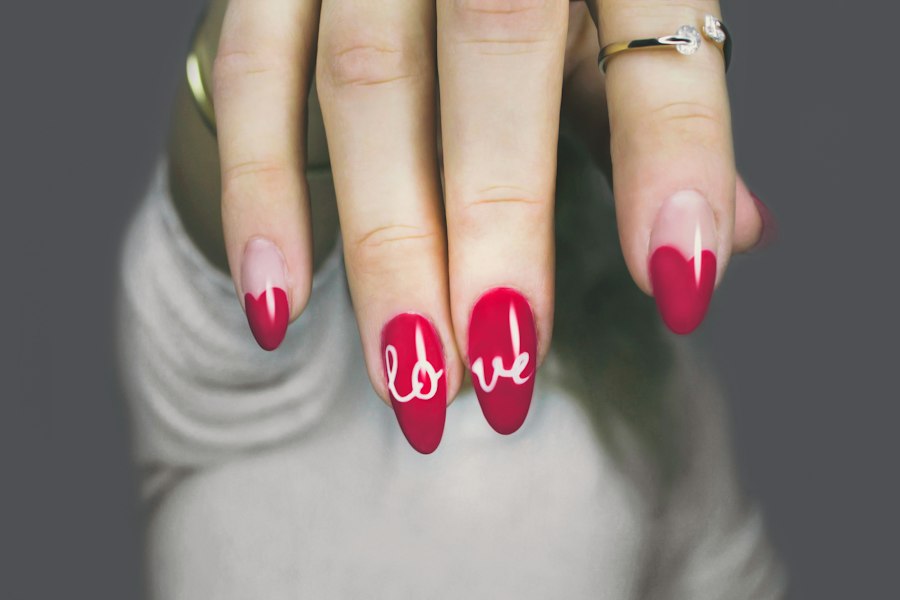 Red almond nails with hand-painted love lettering